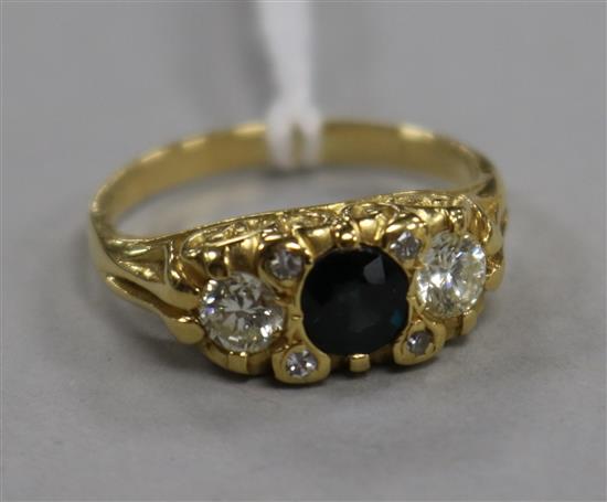 A 1970s 18ct gold, sapphire and diamond three stone ring, size M.